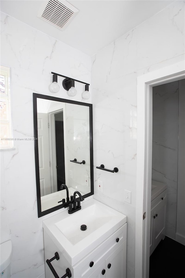 bathroom with vanity and toilet