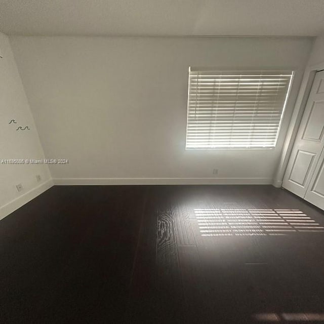 empty room featuring wood-type flooring