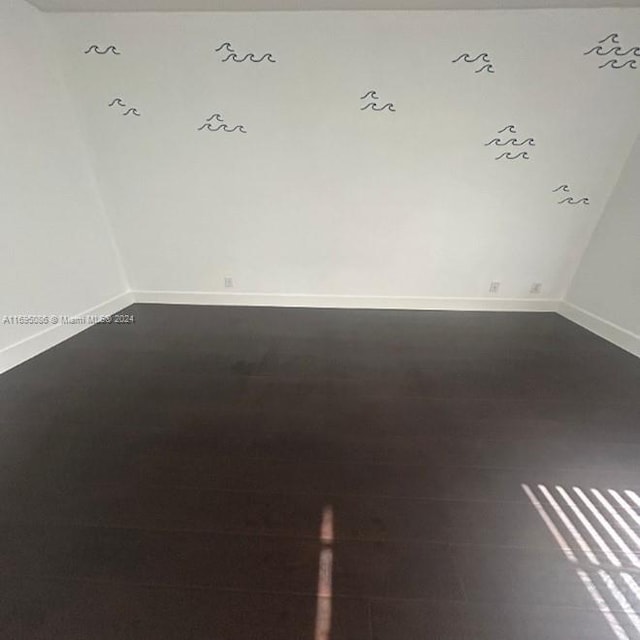 empty room with dark hardwood / wood-style floors