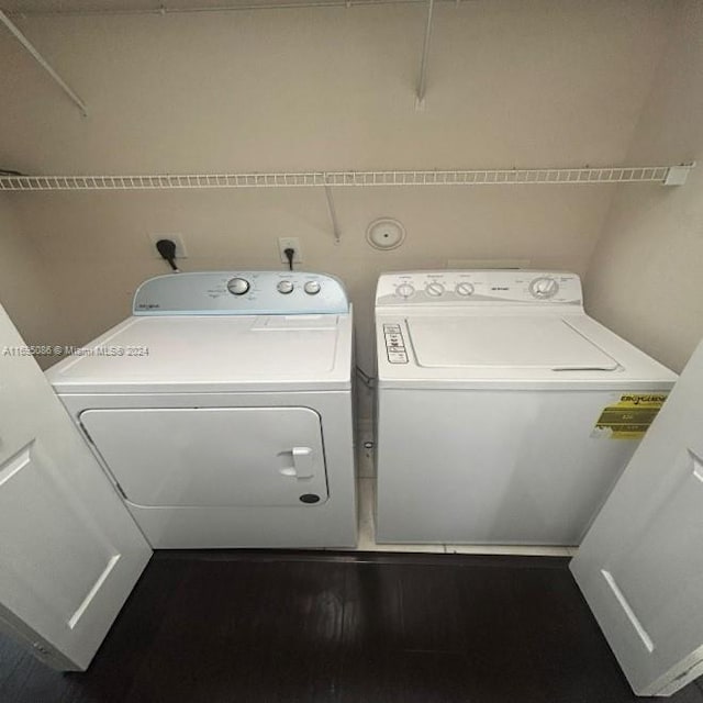 laundry area featuring washer and dryer and dark hardwood / wood-style floors