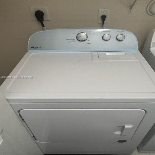 clothes washing area featuring washer and clothes dryer