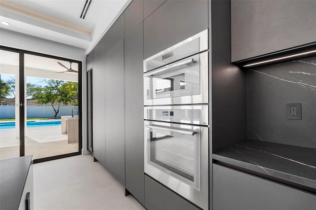 kitchen featuring ceiling fan and stainless steel double oven