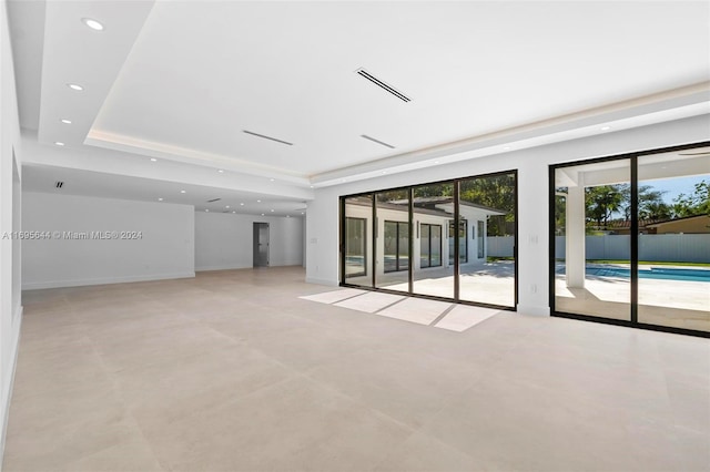 unfurnished room with a tray ceiling