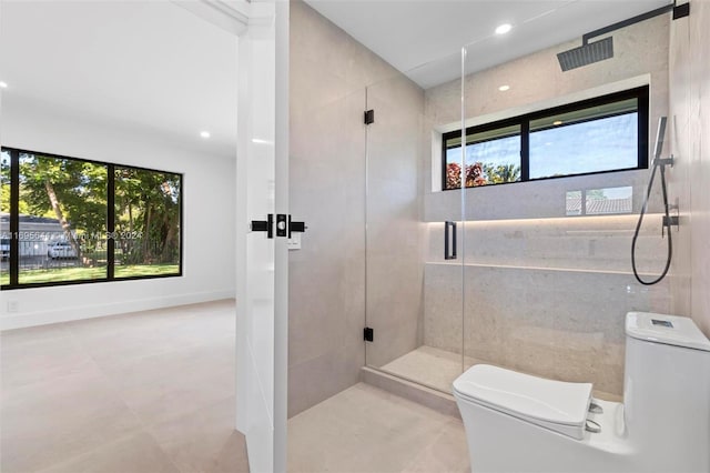 bathroom with toilet, walk in shower, and tile walls