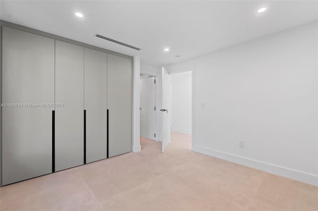 unfurnished bedroom with a closet