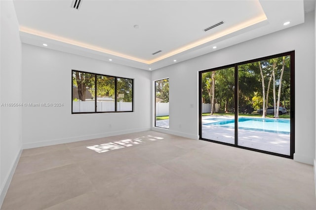 spare room featuring a tray ceiling