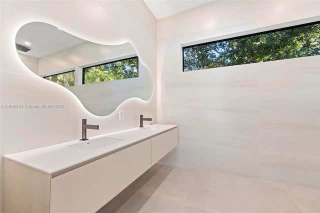 bathroom with tile patterned floors and vanity