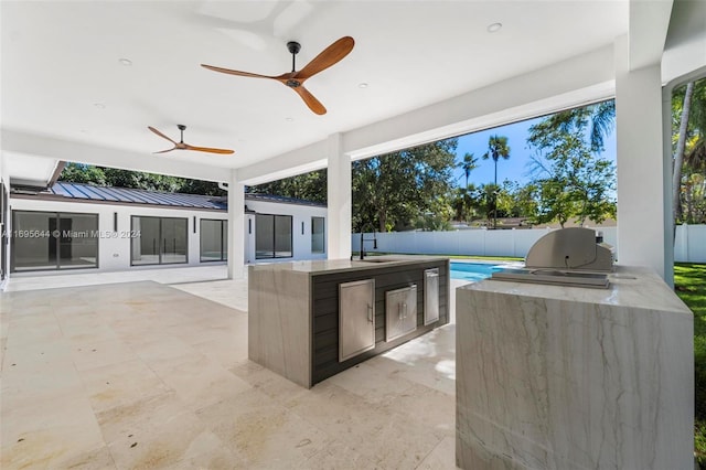 view of patio / terrace featuring ceiling fan, area for grilling, and sink