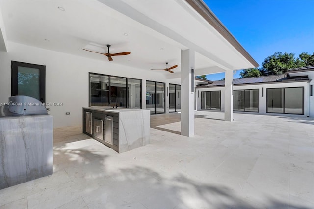 view of patio featuring area for grilling and sink