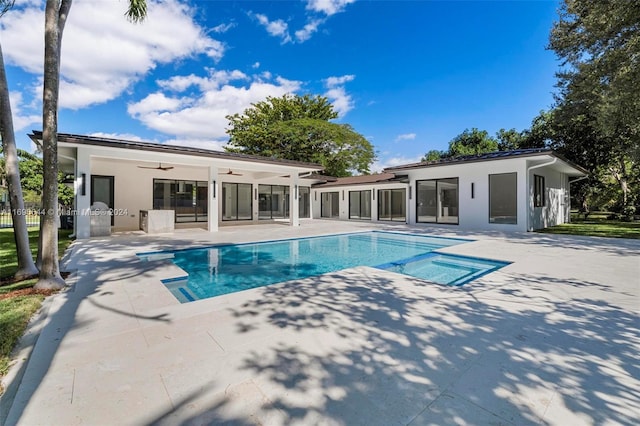 back of house with ceiling fan and a patio area