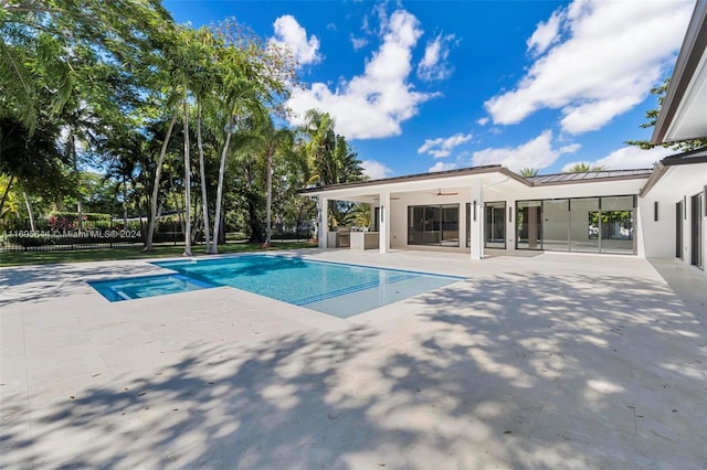 view of swimming pool featuring a patio area and ceiling fan