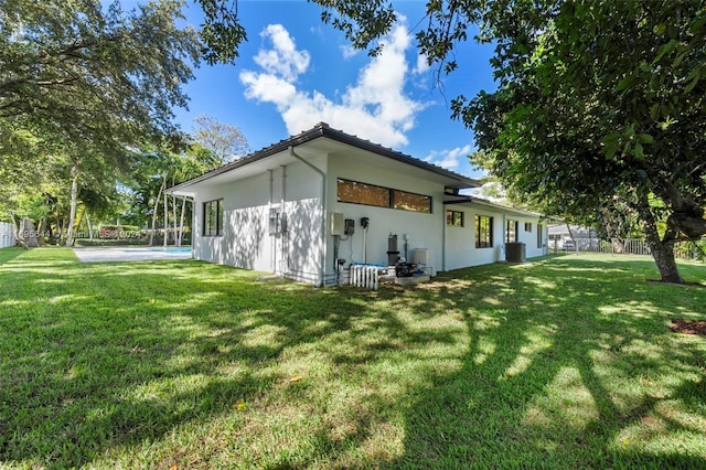 view of side of property featuring a yard and cooling unit