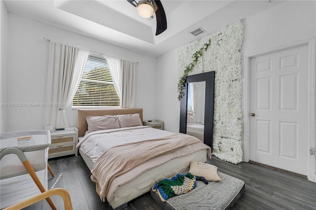 bedroom featuring ceiling fan and dark hardwood / wood-style floors