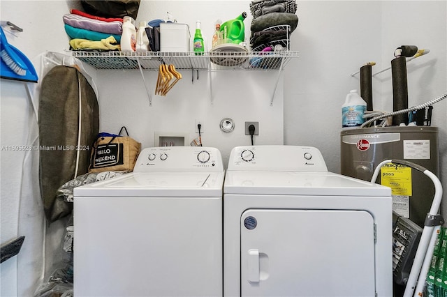 clothes washing area with washing machine and dryer and gas water heater