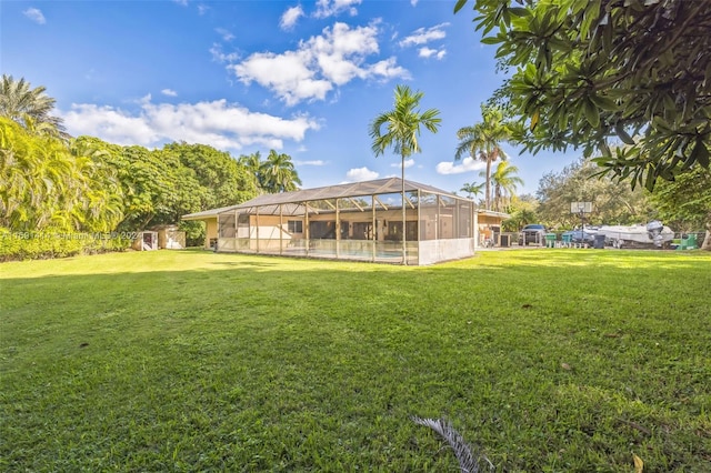 view of yard featuring glass enclosure and a swimming pool