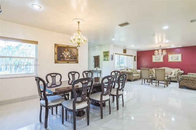 dining room with plenty of natural light and a notable chandelier