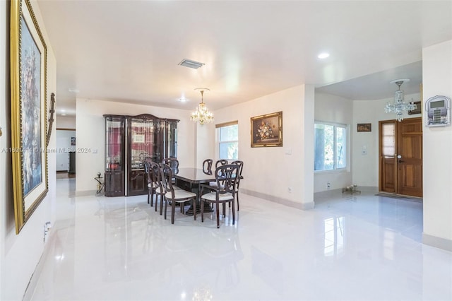 dining space featuring an inviting chandelier