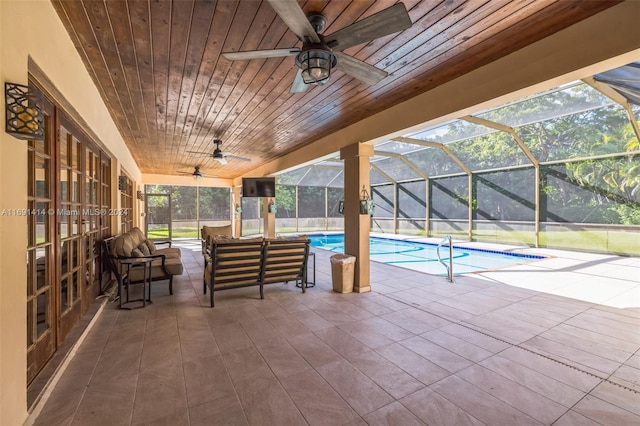 view of swimming pool with a patio and a lanai