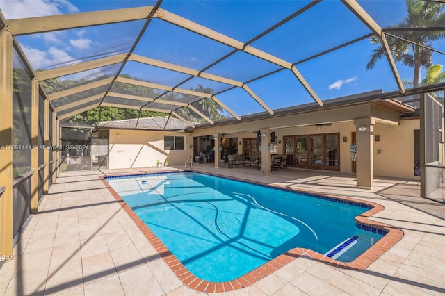 view of swimming pool with french doors, glass enclosure, ceiling fan, and a patio area