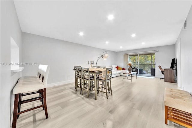 dining area with light hardwood / wood-style flooring