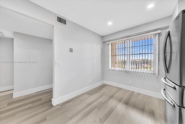 unfurnished room with light hardwood / wood-style flooring