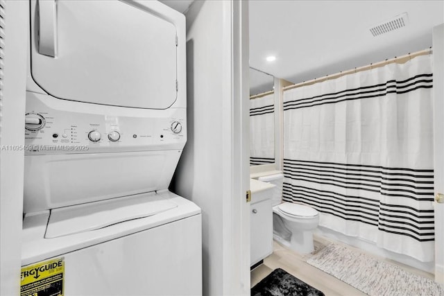 laundry area featuring stacked washer and dryer