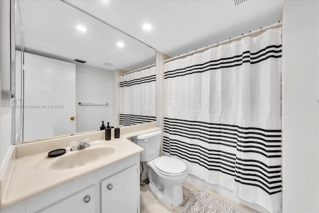 bathroom featuring vanity, a shower with shower curtain, and toilet