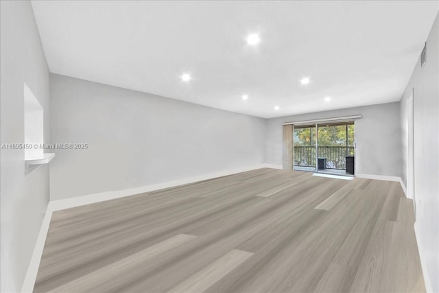 spare room featuring light hardwood / wood-style flooring