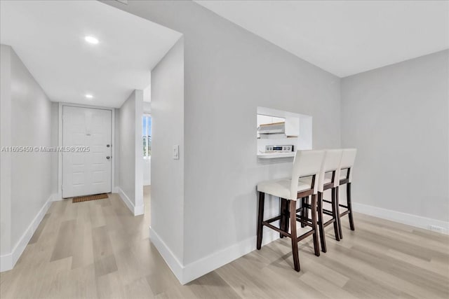 corridor featuring light hardwood / wood-style floors