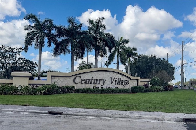 community / neighborhood sign with a yard