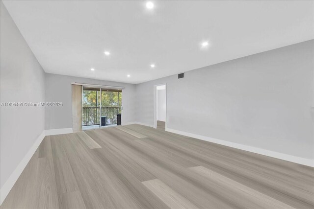 spare room featuring light wood-type flooring