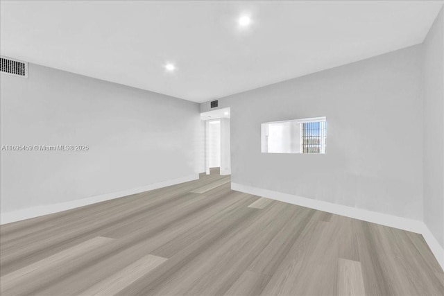 empty room with light hardwood / wood-style flooring