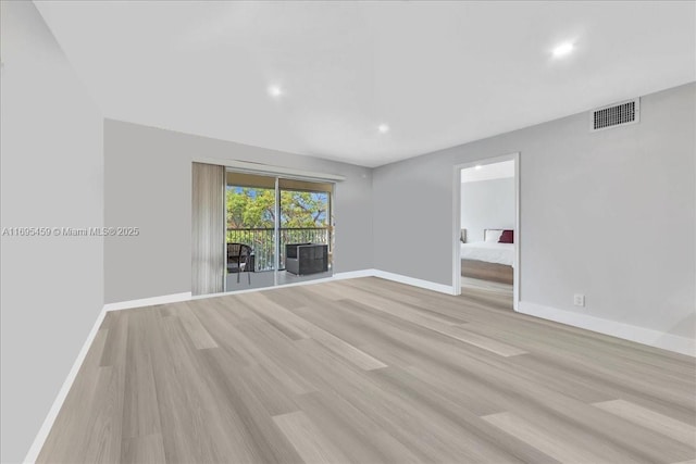 spare room featuring light hardwood / wood-style flooring