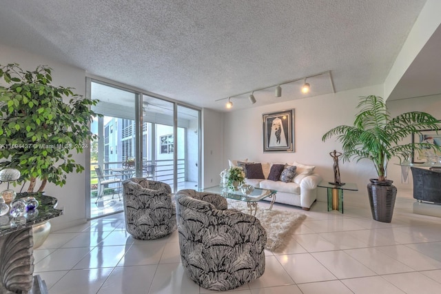 living room featuring light tile patterned floors, a textured ceiling, and track lighting