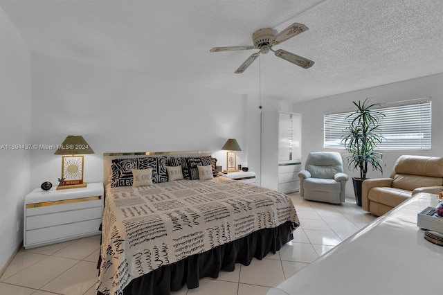 tiled bedroom featuring ceiling fan and a textured ceiling