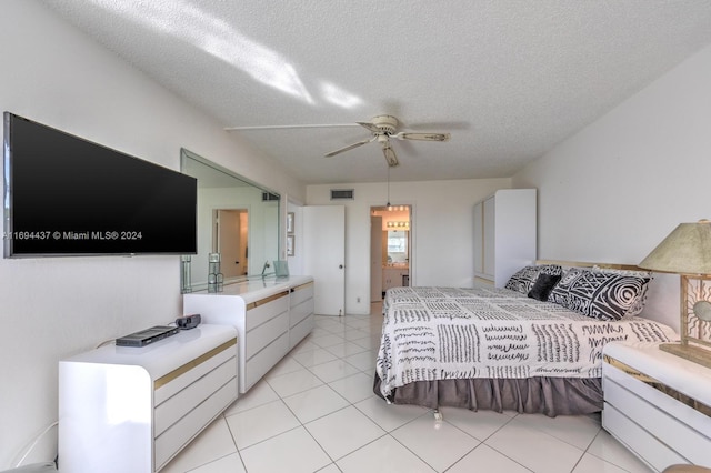 tiled bedroom featuring a textured ceiling and ceiling fan