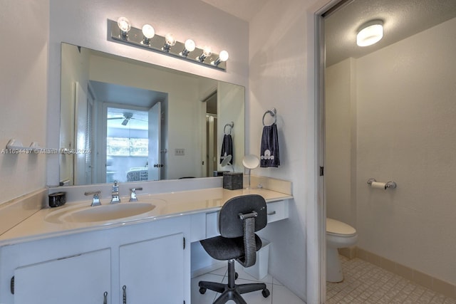 bathroom featuring tile patterned flooring, a textured ceiling, vanity, and toilet