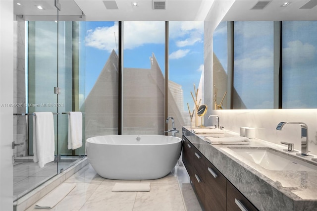 bathroom with shower with separate bathtub, vanity, and expansive windows