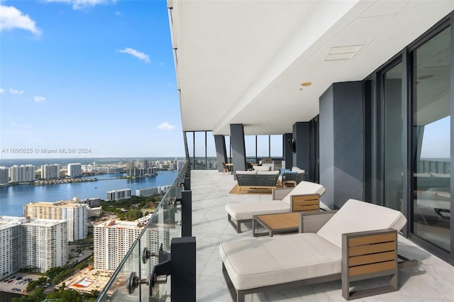 balcony with outdoor lounge area and a water view