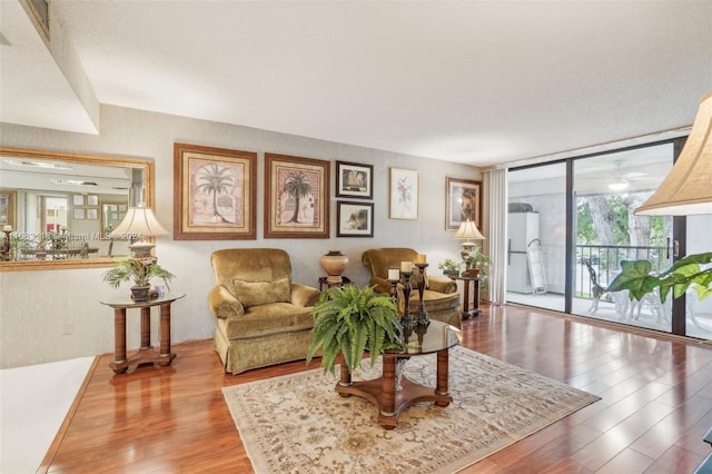 living room with wood-type flooring and expansive windows