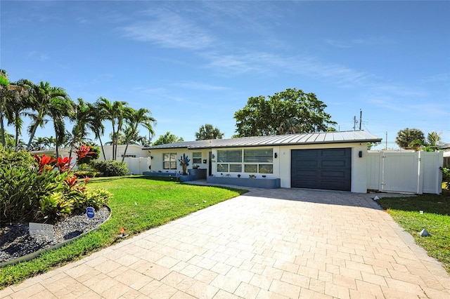 ranch-style house featuring a front yard and a garage