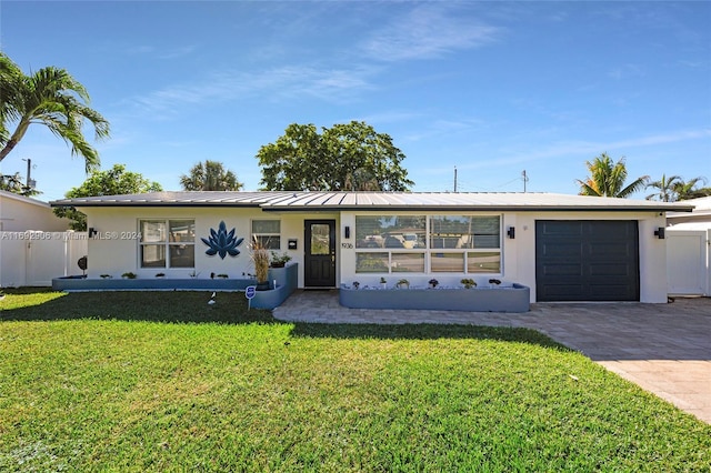 single story home with a front yard and a garage