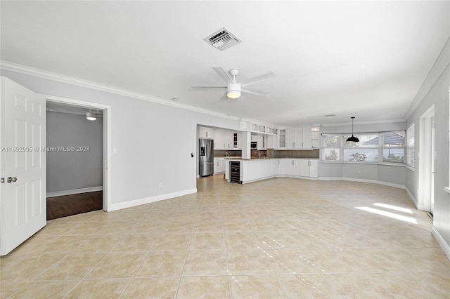 unfurnished living room with ceiling fan, light tile patterned flooring, crown molding, and beverage cooler