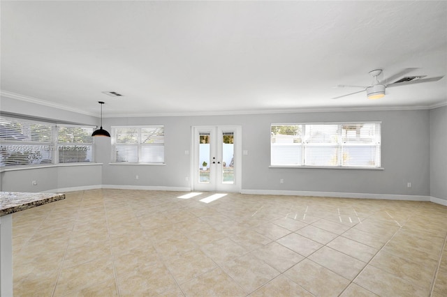 empty room featuring crown molding, ceiling fan, french doors, and a healthy amount of sunlight