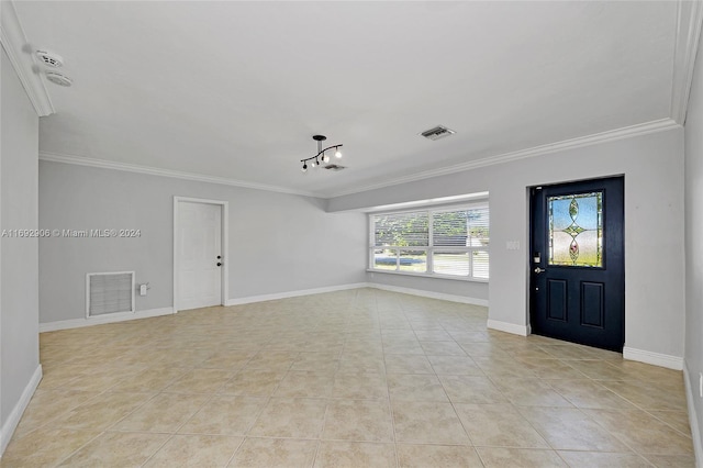 foyer featuring light tile patterned floors, a chandelier, and ornamental molding