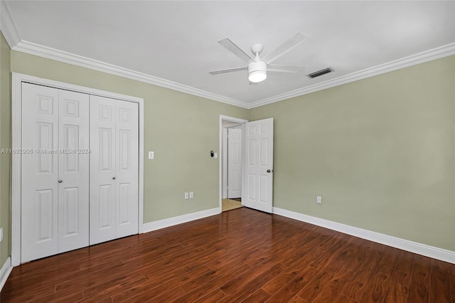 unfurnished bedroom featuring ceiling fan, dark hardwood / wood-style floors, ornamental molding, and a closet