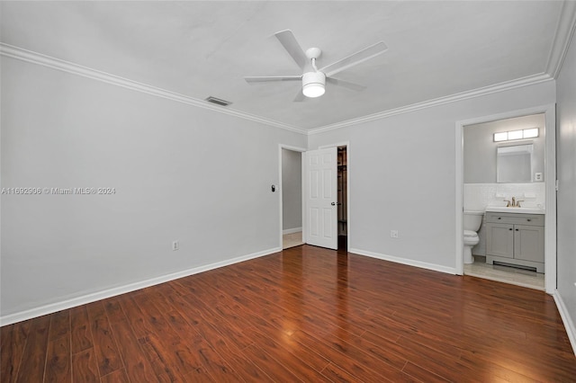 unfurnished bedroom with dark hardwood / wood-style flooring, ceiling fan, crown molding, and connected bathroom