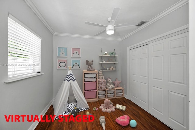 rec room featuring ceiling fan, dark wood-type flooring, and ornamental molding