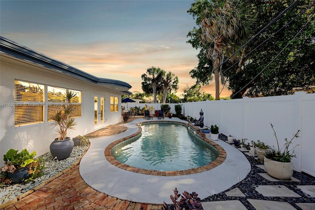 view of pool at dusk