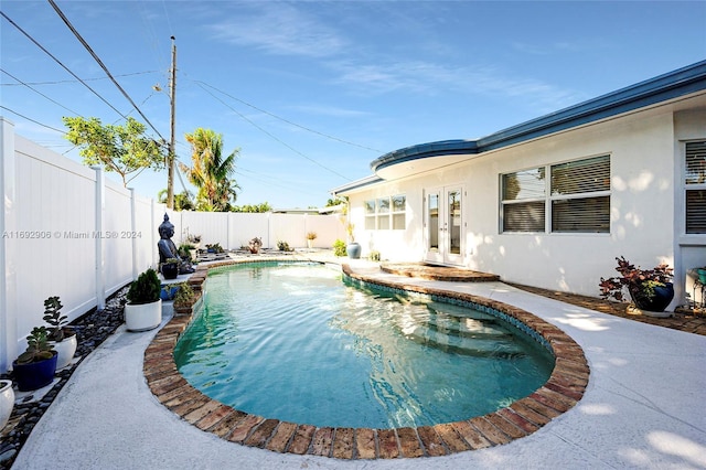 view of pool featuring french doors